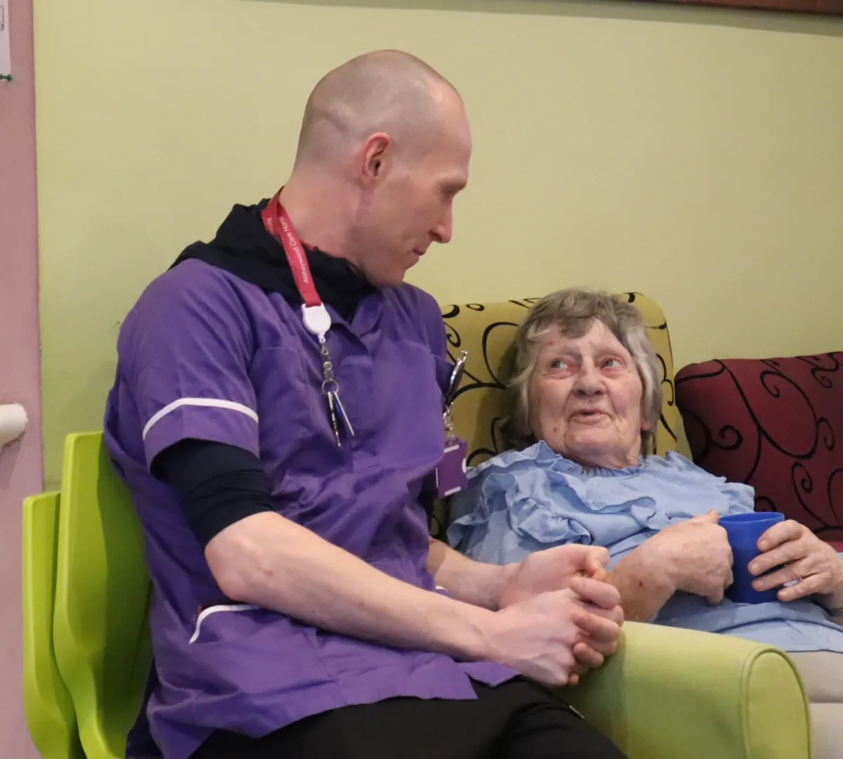 Care Assistant in Bury sat with elderly resident
