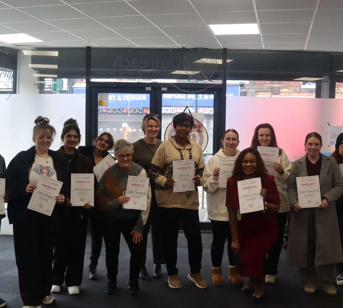 Care Staff in Bury photographed with certificates