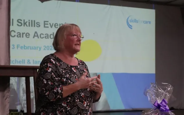 Presenter from Skills for Care shown from the side presenting to the audience